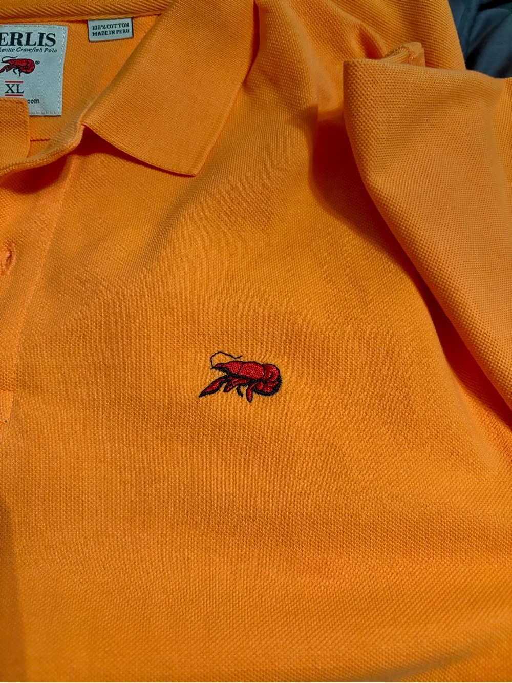 Boys Orange Polo with Contrast Chest Emblem of crawfish